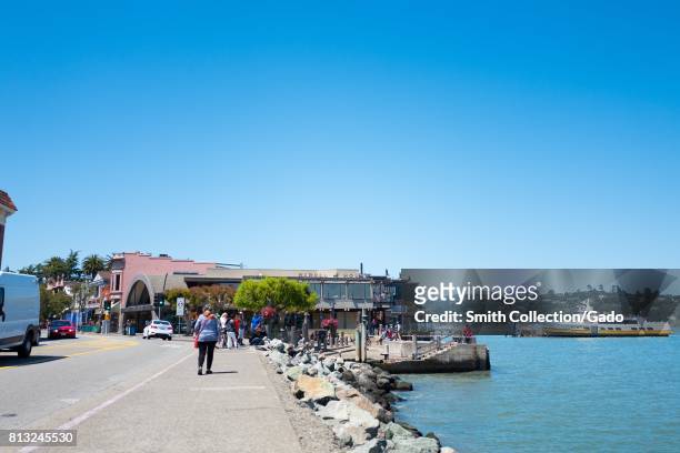 San Francisco ferry is visible, along with downtown businesses, on Bridgeway Road in the San Francisco Bay Area town of Sausalito, California, June...
