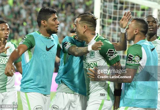 Dayro Moreno of Atletico Nacional celebrates with teammates, Luis Carlos Ruiz and Aldo Leao Ramirez after scoring the fourth goal of his team during...