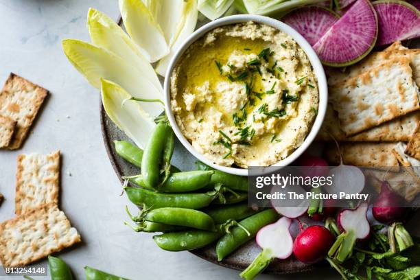 spring vegetables and hummus on a platter - crackers stock pictures, royalty-free photos & images