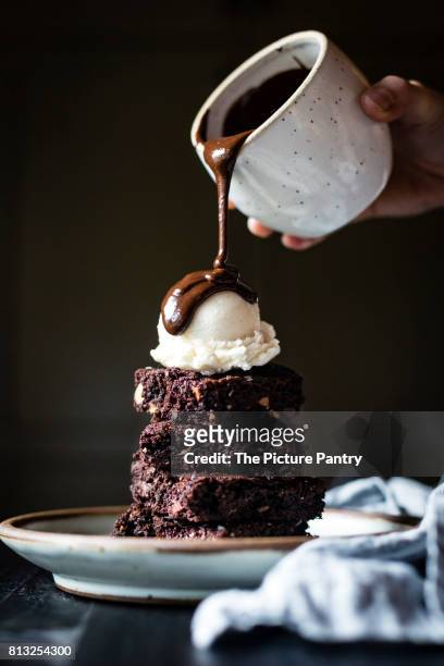 a brownie sundae - chocolate sauce stock pictures, royalty-free photos & images