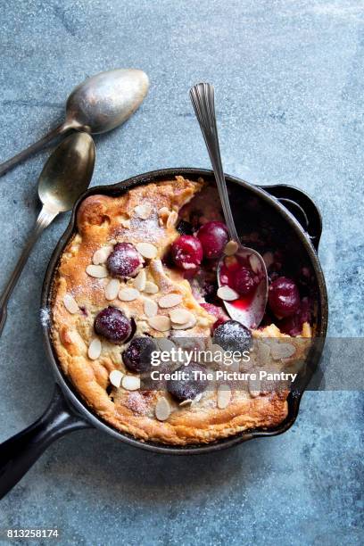 cherry clafoutis with almonds on a dutch pan.top view - cherry on top stock-fotos und bilder