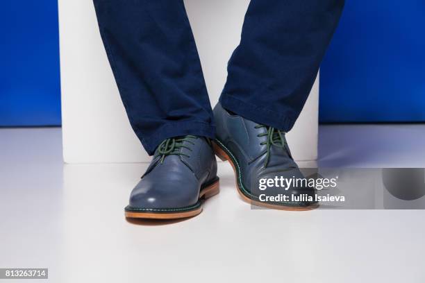 male feet in shoes on studio background - smart shoes stock pictures, royalty-free photos & images