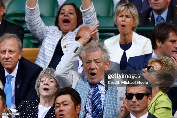 Sir Ian McKellen and Dame Maggie Smith react in the centre court royal box during the Gentlemen's Singles quarter final match between Andy Murray of...