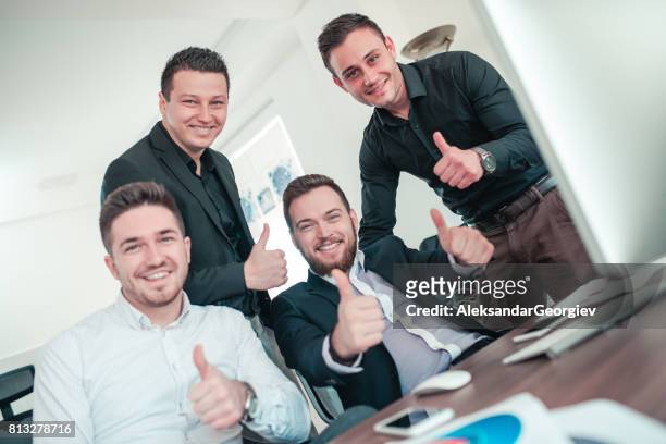 group of young smiling coworkers have great day at business modern office with thumbs up - teasing stock pictures, royalty-free photos & images