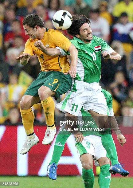 Australia's Scott MacDonald vies for the ball with Iraq's Hawar Thaer and Nashat Akram Abid Ali during their World Cup qualifying fooball match in...