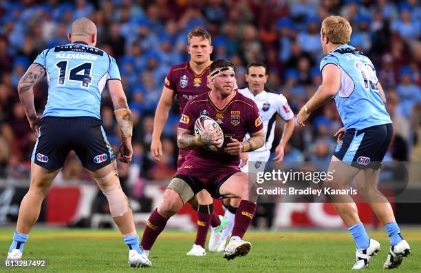 Josh McGuire of the Maroons takes on the defence during game three of the State Of Origin series between the Queensland Maroons and the New South...