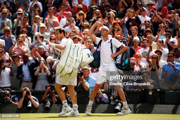 Dejected Andy Murray of Great Britain acknowledges the crowd as Sam Querrey of The United States celebrates after the Gentlemen's Singles quarter...