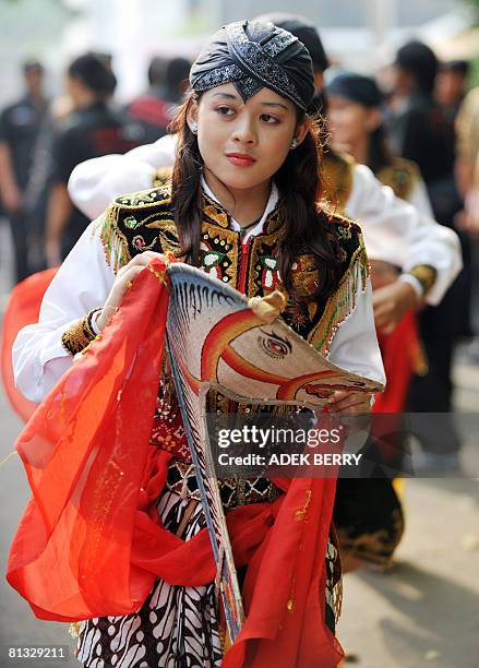 Dancers perform Reog Ponorogo on a street in Jakarta on May 31, 2008. Reog Ponorogo is particapated by several dancers wearing bright colorful...