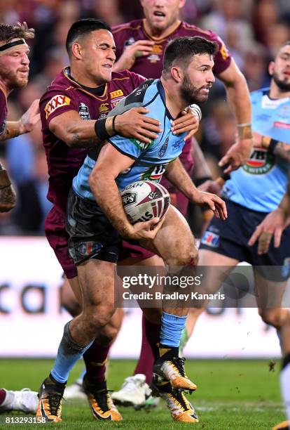 James Tedesco of the Blues is tackled during game three of the State Of Origin series between the Queensland Maroons and the New South Wales Blues at...