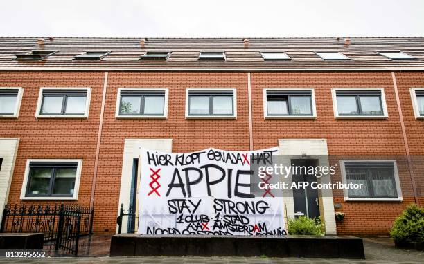 Banner reading 'Here beats a Ajax heart. Stay Strong Appie' stands in the garden in front of the house of Ajax Amsterdam footballer Abdelhak Nouri in...