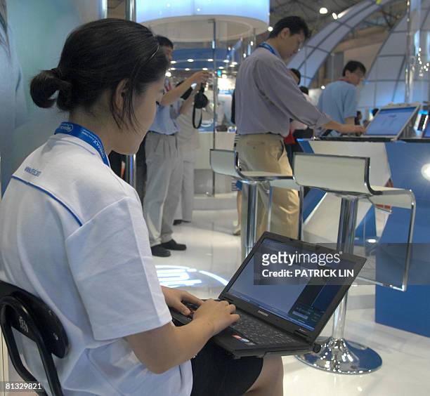 Staff operates a laptop at a booth of Asia's biggest computer show also known as "Computex" in Taipei on June 2, 2008. More than 1,700 exhibitors...