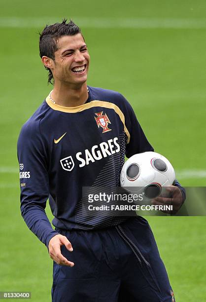 Portugal's football team player forward Cristiano Ronaldo laught with the ball during the squad first training session at the Maladiere Stadium in...