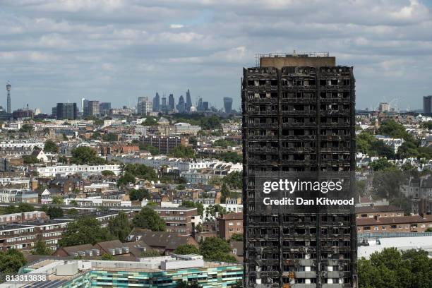 The City of London skyline is seen behind the remains of Grenfell Tower on July 12, 2017 in London, England. 80 people have been confirmed dead and...