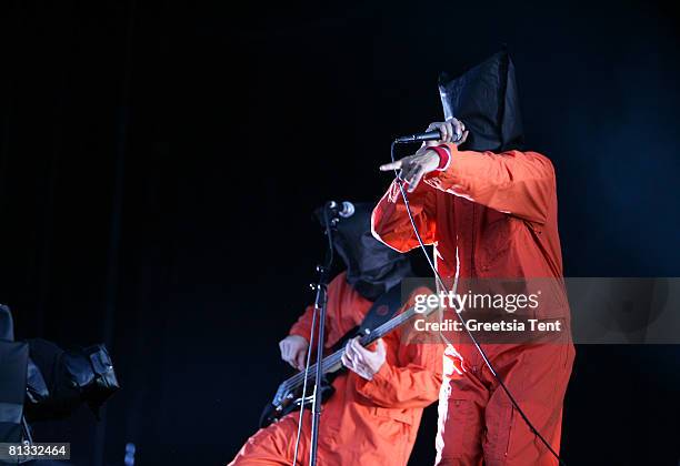 Tim Commeford and Zack de la Roche of the band Rage Against The Machine dress up as Guantanamo Bay prisoners, in orange jumpsuits and black hoods in...