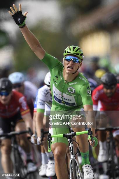 Germany's Marcel Kittel, wearing the best sprinter's green jersey, makes the sign five for his fifth consecutive victory as he crosses the finish...