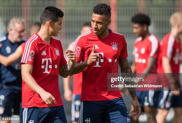 James Rodriguez talks to Corentin Tolisso during a training session at Saebener Strasse training ground on July 12, 2017 in Munich, Germany.