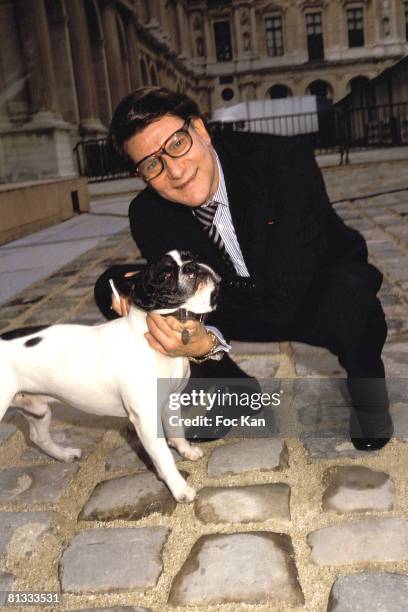 Yves Saint Laurent and his French Bulldog attend the Miro Exhibition at the Pompidou Center Museum on January 15, 2000 in Paris France.
