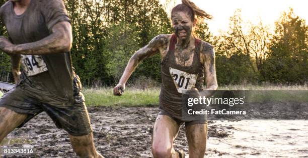 strong woman - mud runner stock pictures, royalty-free photos & images