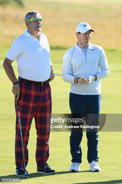 Rory McIlroy of Northern Ireland speaks to Gavin Hastings, former Scottish former rugby union player during a Pro-Am prior to the AAM Scottish Open...