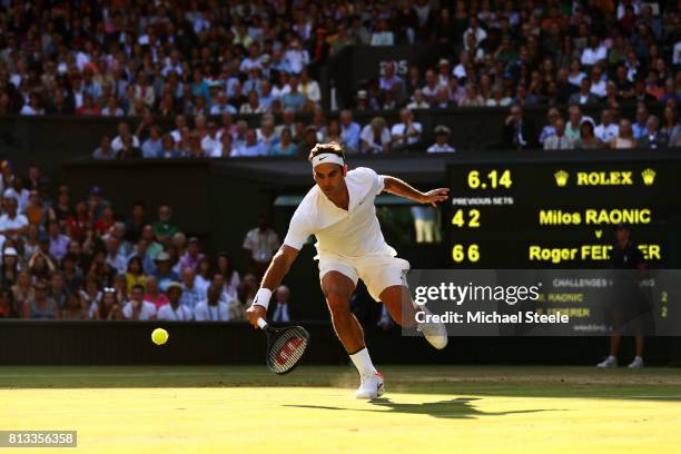Roger Federer of Switzerland plays a backhand during the Gentlemen's Singles quarter final match against Milos Raonic of Canada on day nine of the...