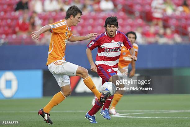 Bobby Boswell of the Houston Dynamo defends the ball from FC Dallas midfielder Juan Toja on May 24, 2008 at Pizza Hut Park in Frisco, Texas. The...