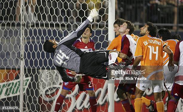 Dallas goalkeeper Dario Sala dives to make a save as Blake Wagner of FC Dallas, Drew Moor of FC Dallas, Bobby Boswell of the Houston Dynamo, Dwayne...