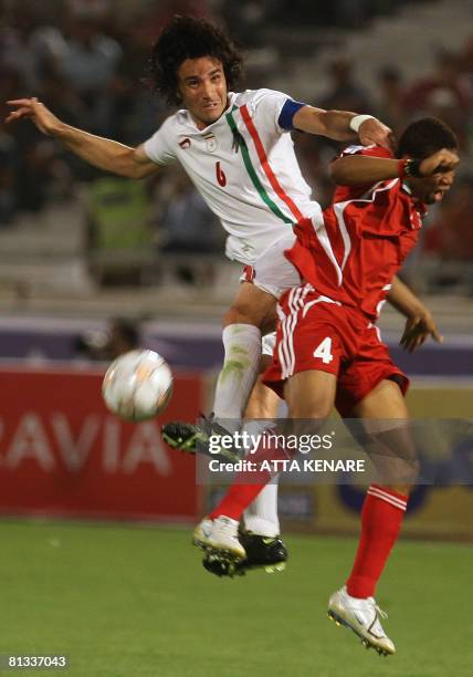 Iran's Javad Nekounam vies for the ball with UAE's Subait Khater during their Group 5 Asian World Cup qualifying football match at Tehran's Azadi...