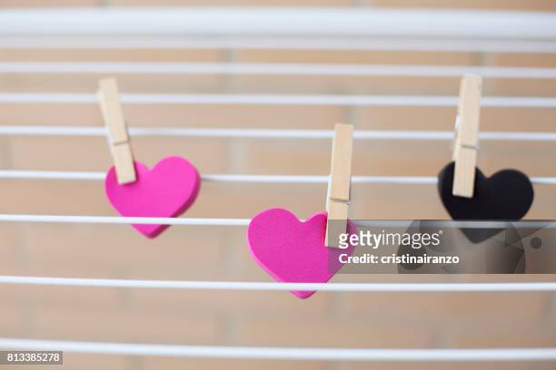 hearts lying on a clothesline - infidelity bildbanksfoton och bilder