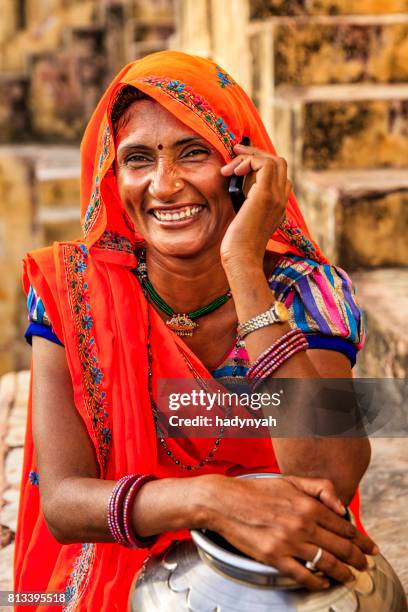 indian woman using mobile phone, village near jaipur, india - stepwell india stock pictures, royalty-free photos & images