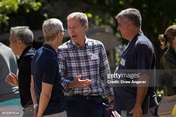 Tim Cook, chief executive officer of Apple, Jeff Bewkes, chief executive officer of Time Warner, and Eddy Cue, senior vice president of internet...