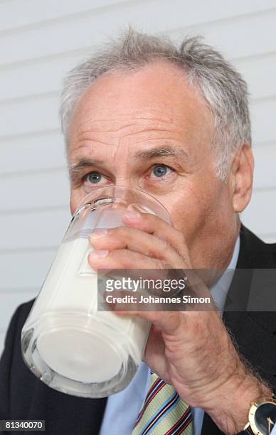 Erwin Huber, head of the CSU and Bavarian Economic Minister drinks milk in front of the cow barn of milk farmer Hans Doeringer during a discussion...