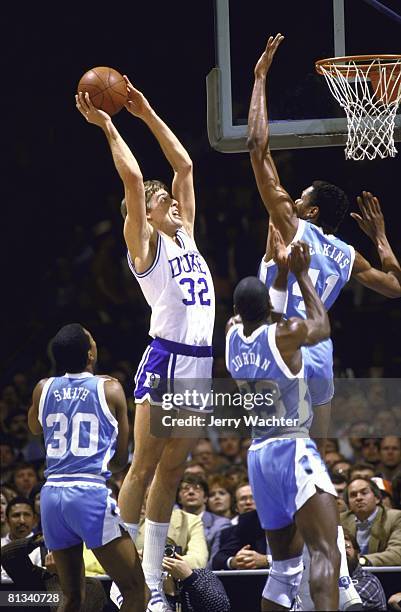 Playoffs, Duke Mark Alarie of the Duke Blue Devils goes up for a shot against Sam Perkins of the North Carolina Tar Heels on March 10, 1984 in...