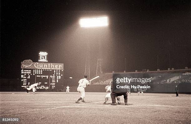 Baseball: Baltimore Orioles Chico Garcia in action, making bunt vs Cleveland Indians Bob Lemon, View of Memorial Stadium, Baltimore, MD 8/21/1954