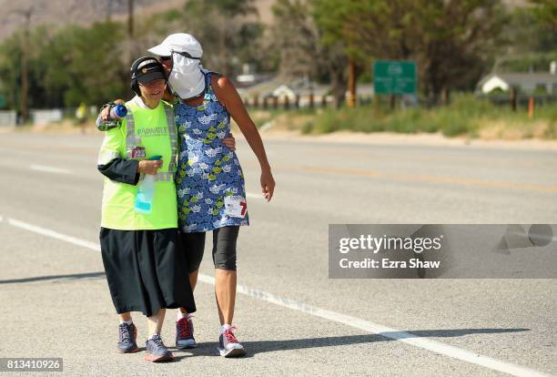 Lisa Smith-Batchen gives a kiss to Sister Mary Beth Lloyd, a member of her support team, during the STYR Labs Badwater 135 on July 12, 2017 in Death...