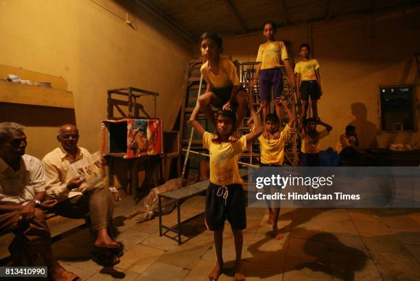 Children are trained for a new technique called teen ekke where three children stand on eachother at the top of the pyramid. Young, lanky children...