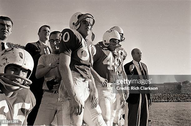 College Football: Nebraska coach Bob Devaney with assistant coach Tom Osborne on sidelines during game vs Kansas, Lincoln, NE 11/9/1963