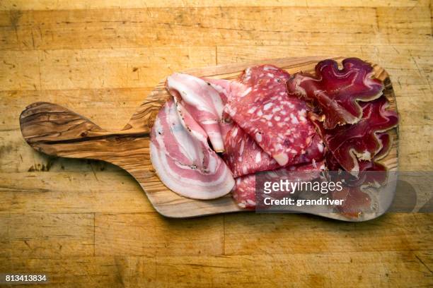 small charcuterie plate with ham, salami and prosciutto - cutting board stock pictures, royalty-free photos & images