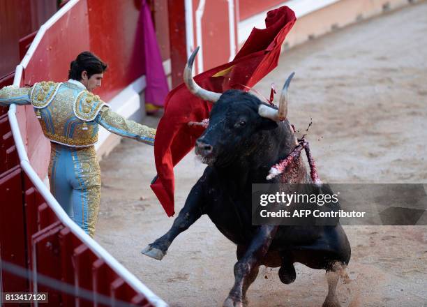 French matador Sebastian Castella performs a pass on a Victoriano del Rio Cortes' fighting bull during the sixth bullfight of the San Fermin Festival...