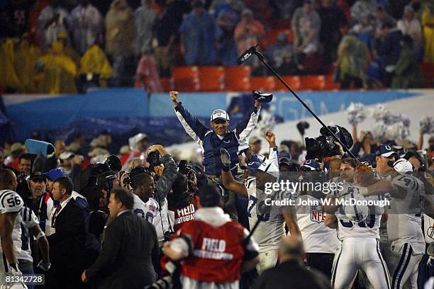 Football: Super Bowl XLI, Indianapolis Colts coach Tony Dungy victorious, getting carried off field by team after winning game vs Chicago Bears, View...