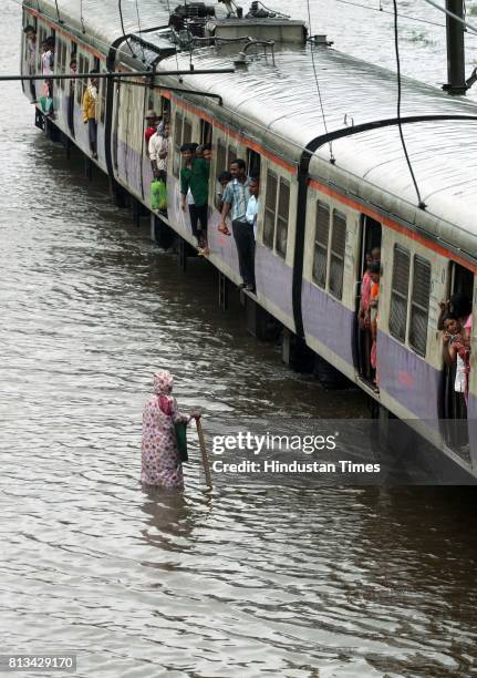 Railway track were flooded due to heavy rain and disrupted rain traffic at Kurla in Mumbai on Monday.