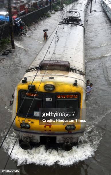 Railway track were flooded due to heavy rain and disrupted rain traffic at Kurla in Mumbai on Monday.
