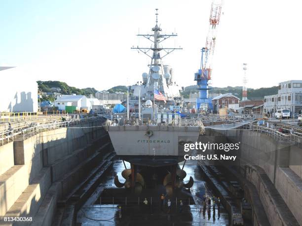 In this handout provided by the U.S. Navy, The Arleigh Burke-class guided-missile destroyer USS Fitzgerald sits in Dry Dock 4 at Fleet Activities...