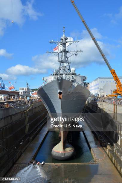 In this handout provided by the U.S. Navy, The Arleigh Burke-class guided-missile destroyer USS Fitzgerald sits in Dry Dock 4 at Fleet Activities...