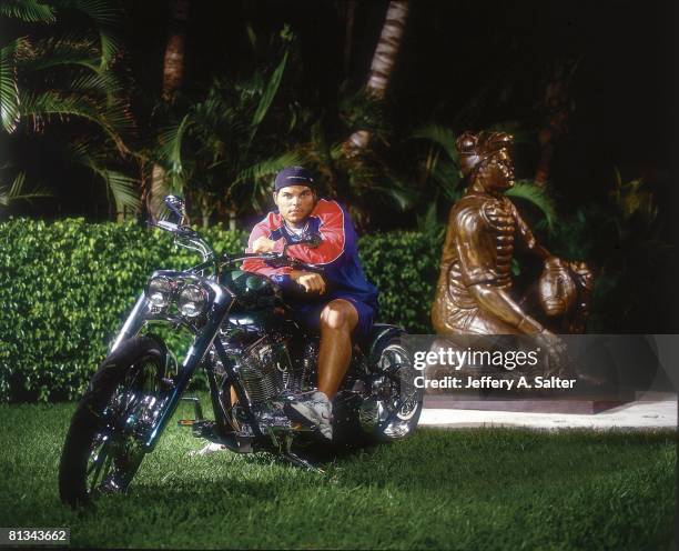 Baseball: Casual portrait of Texas Rangers Ivan Pudge Rodriguez on his motorcycle with statue of himself in his backyard, Miami, FL