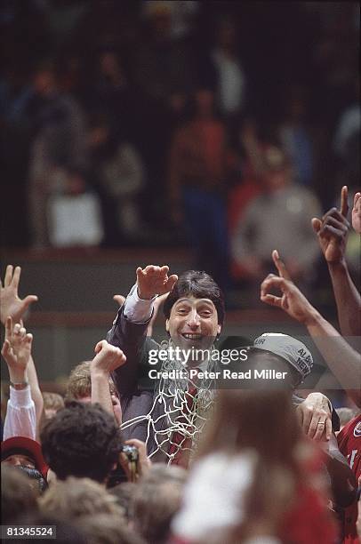 College Basketball: NCAA Final Four, North Carolina State coach Jim Valvano victorious with net after winning game vs Houston, Albuquerque, NM...