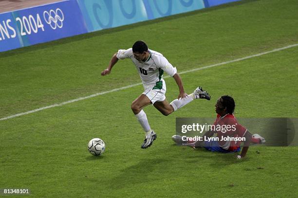Soccer: 2004 Summer Olympics, Iraq Younis Mahmoud in action vs Costa Rica Junior Diaz during First Round - Group D match at Karaiskaki Stadium,...