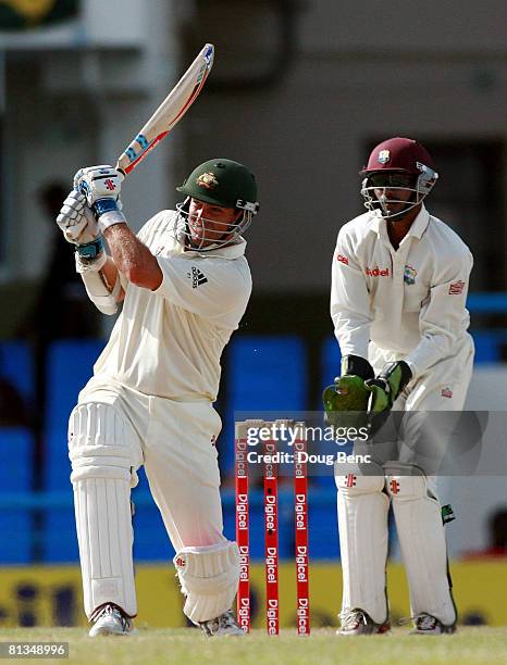 Phil Jaques of Australia hits a six as Denesh Ramdin of West Indies looks on during day four of the Second Test match between West Indies and...