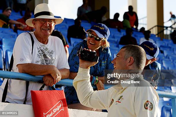 Stuart MacGill of Australia brings his camcorder out on to the field at the end of play on day four of the Second Test match between West Indies and...