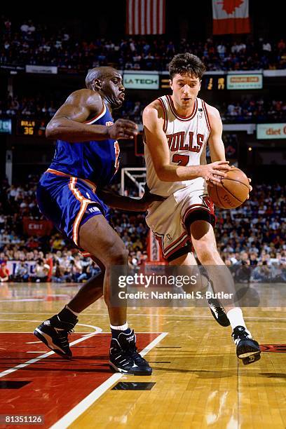 Tony Kukoc of the Chicago Bulls drives to the basket against Anthony Mason of the New York Knicks in Game Three of the Eastern Conference Semifinals...