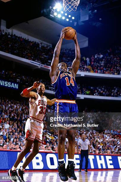 Anthony Mason of the New York Knicks grabs the rebound against Scottie Pippen of the Chicago Bulls in Game Six of the Eastern Conference Semifinals...